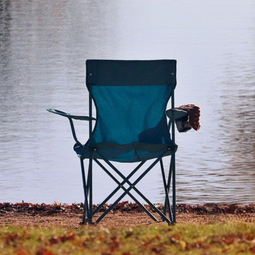 Blue fishing chair in front of a lake.