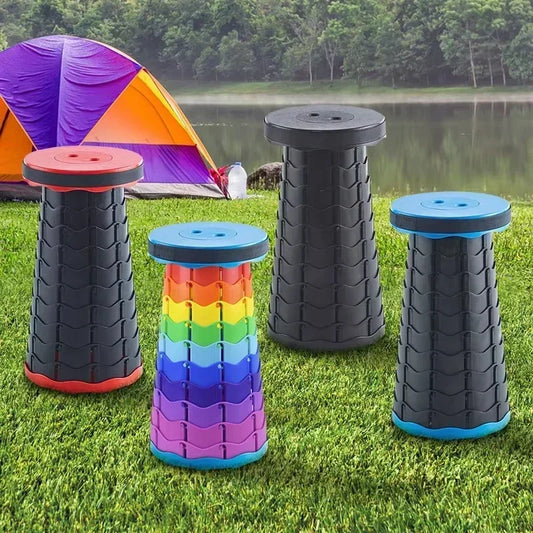 Set of colorful folding stools on grass with a tent and lake in the background